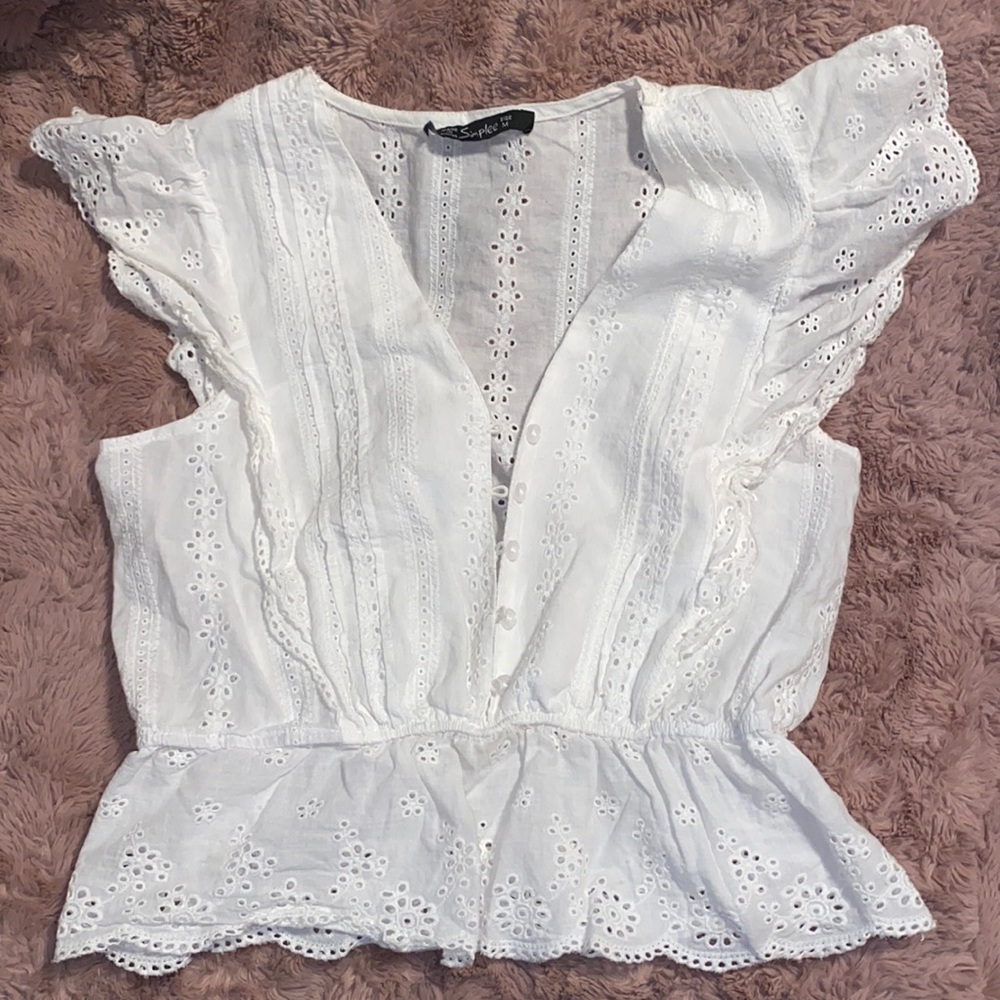 Simple, white button up top with floral/cut detail